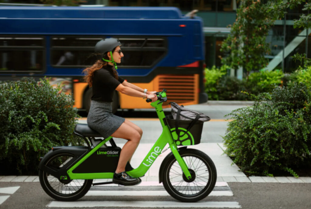 Image shows a woman riding a LimeGlider.
