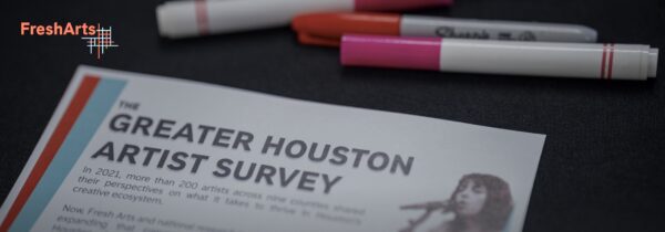 A page reading "Greater Houston Artist Survey" on a table with red, orange, and pink markers and a "Fresh Arts" logo.