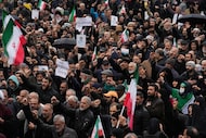 People chant slogans during the funeral procession of Iran's intelligence minister Esmail...