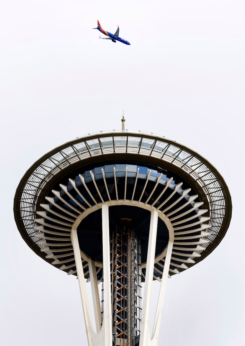 A Southwest Airlines flight inbound from Oakland passes over the Space Needle in downtown...