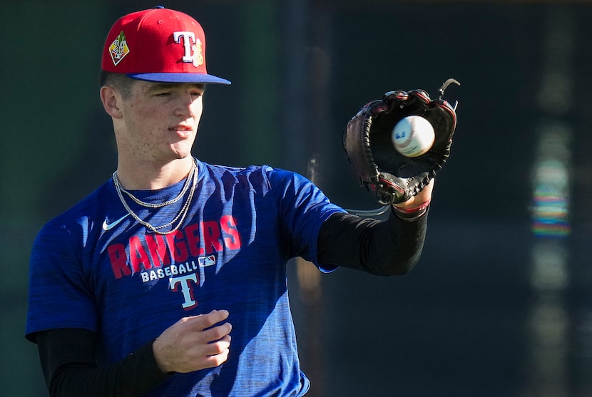 Texas Rangers minor league pitcher Jacob Johnson throws in the outfield during a spring...