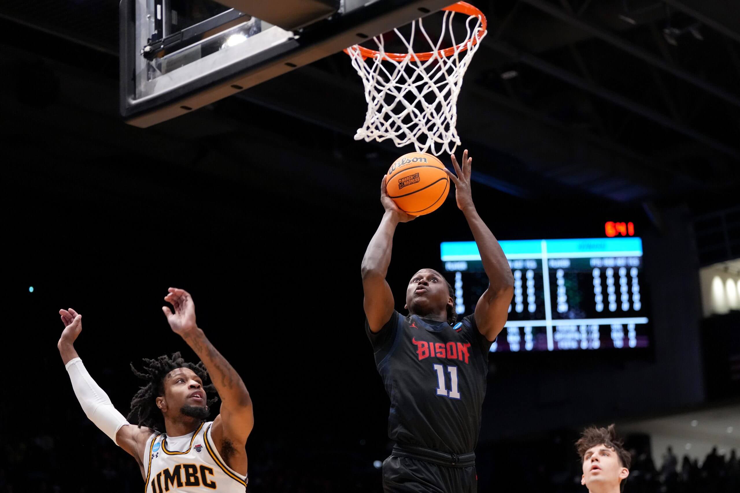 Howard guard Ose Okojie shoots the ball as UMBC forward DJ Armstrong defends during a First Four game in the NCAA Tournament.