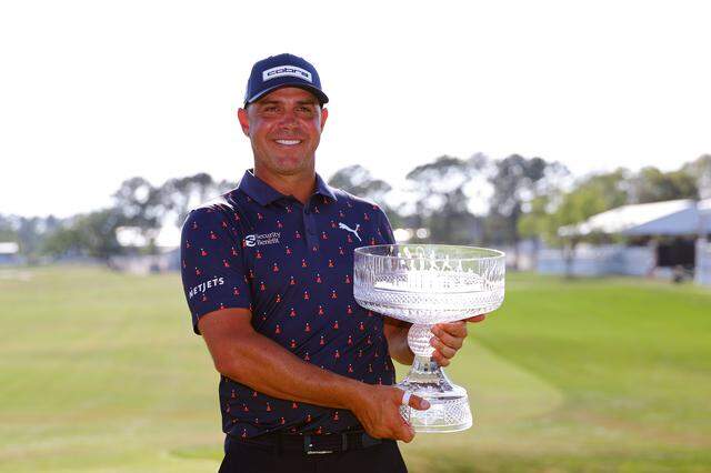 Gary Woodland poses with the trophy on the 18th green after winning the Texas Children's Houston Open 2026 at Memorial Park Golf Course on March 29, 2026 in Houston.