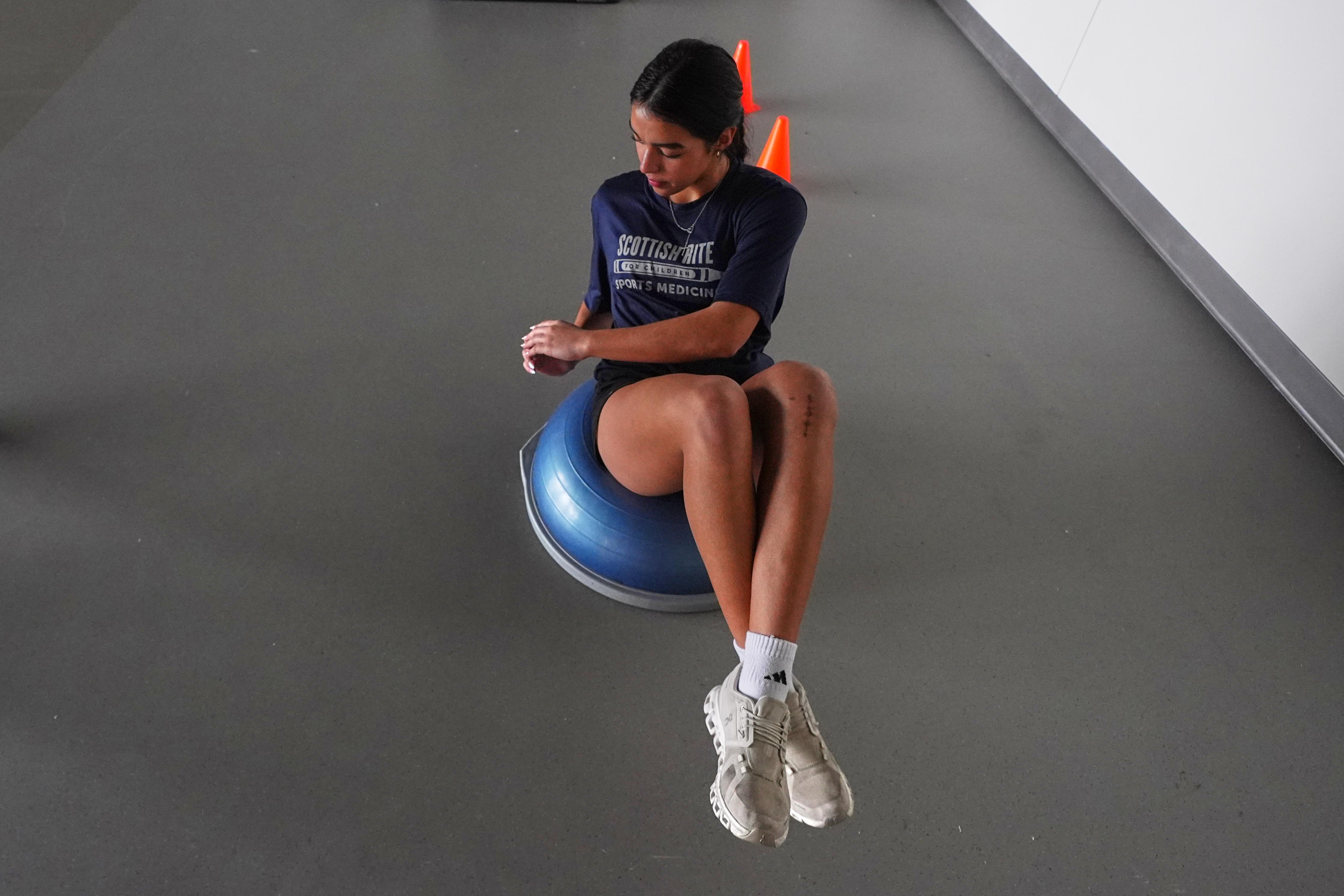 Plano East High School soccer player Sofia Tepichin works to strengthen her knees.