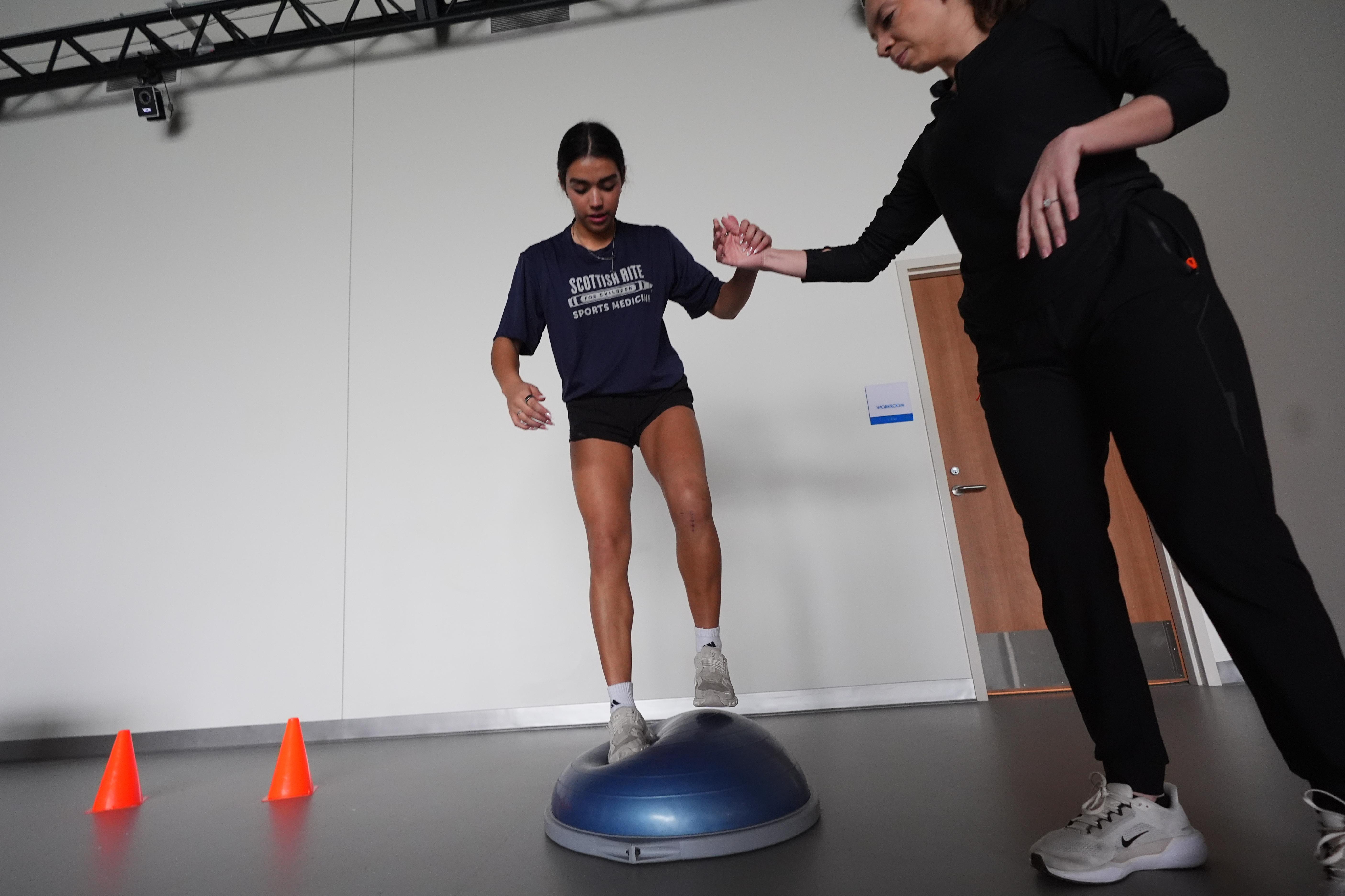 Plano East High School soccer player Sofia Tepichin stands on a balance trainer.