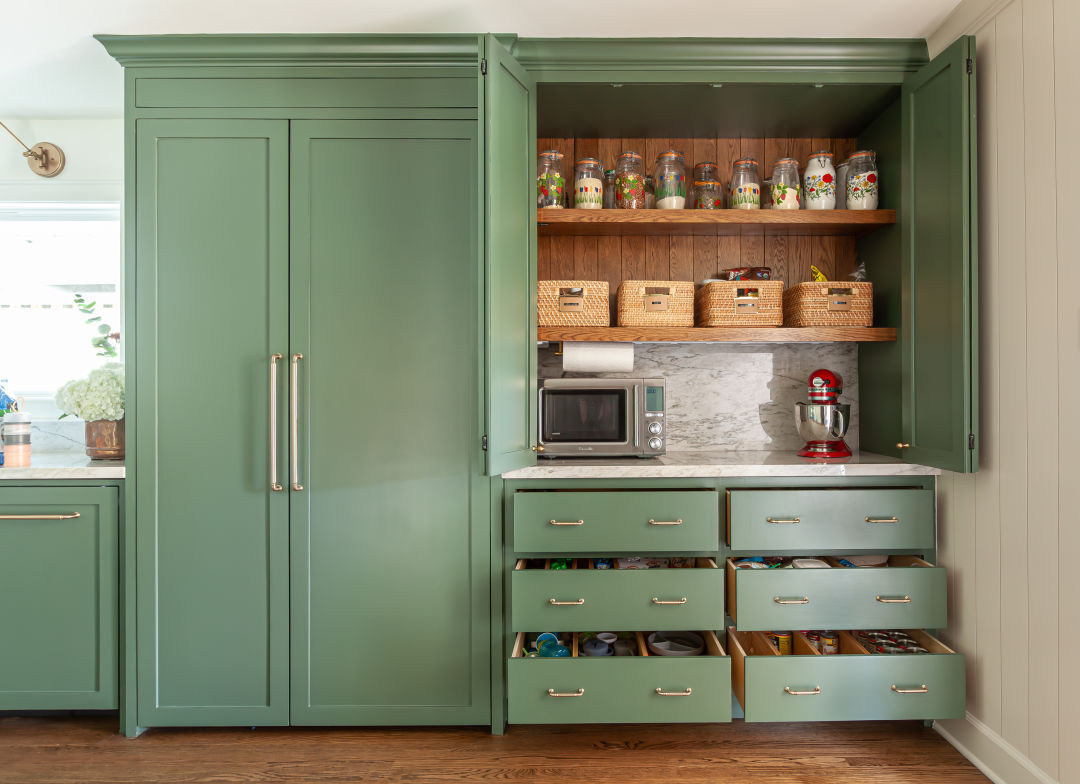 An avocado green kitchen pantry with kitchen appliances and organizers inside.