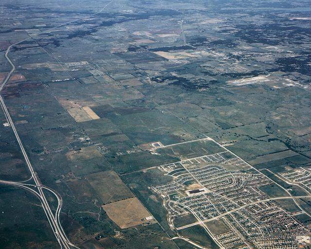 1988: This photo shows the undeveloped east side of Interstate 35W before North Tarrant Parkway and Heritage Trace Boulevard were built. The U.S. 287 ramps are seen to the lower left. The neighborhood shown is Summerfields.