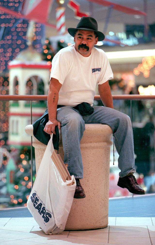 Dec. 22, 2000: Jose Contreras of Fort Worth waits outside of K-B Toys while his wife shops for their grandchildren in Ridgmar Mall.