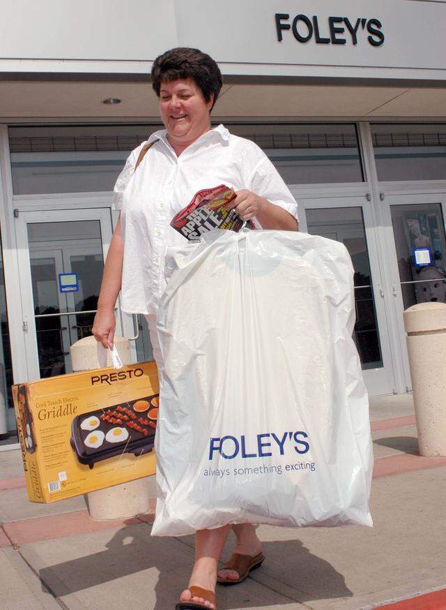 Aug. 6, 2004: Jennifer Carr walks out of Ridgmar Mall caring back to school clothes taking advantage of the state's tax free days