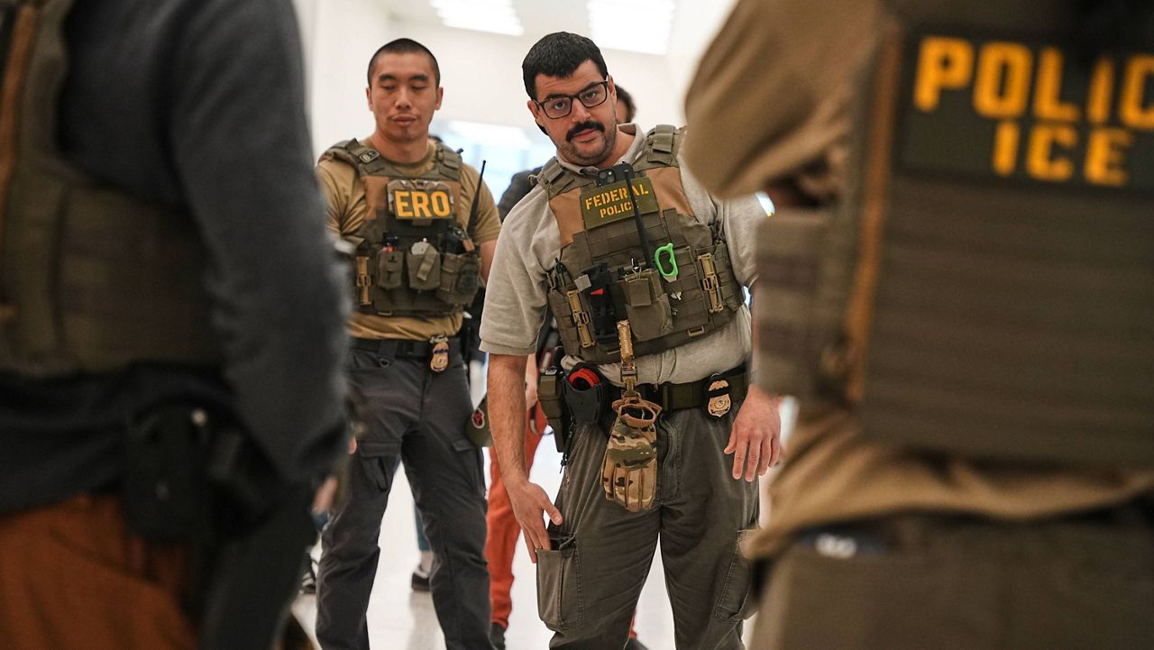 Federal immigration agents are seen at Newark Liberty International Airport, Monday, March 23, 2026, in Newark, N.J. (AP Photo/Angelina Katsanis)