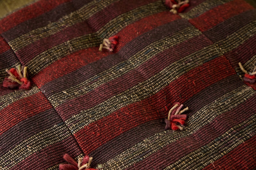 Close view of plum and red textured fabric