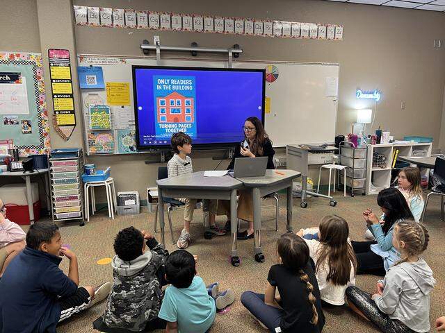 Second-graders listen as their classmate Kylo Weisberg discusses “26-Storey Treehouse” by Andy Griffiths with teacher Christi Cooper while recording an episode of the podcast, “Only Readers in the Building – Turning Pages Together,” on Thursday, March 12, 2026. Cooper’s students discuss books they’re reading on the podcast twice a week, which is available to the Heritage Elementary School community in Grapevine-Colleyville ISD.