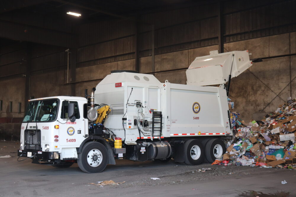 A newly purchased recycling truck unloads at the city's recycling plant in late September.