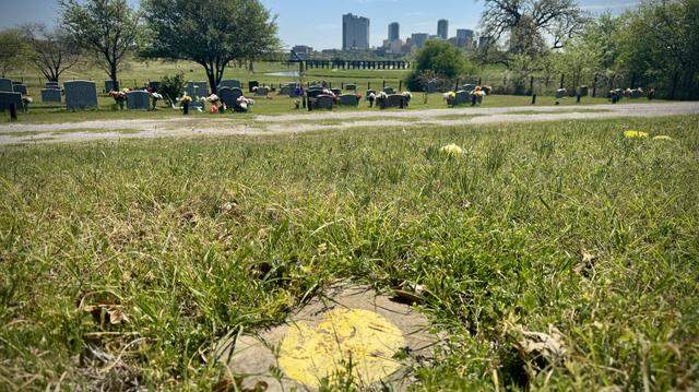A simple stone with a yellow circle at Oakwood Cemetery marks the grave of an Indigenous woman whose remains were discovered during construction in downtown Fort Worth in 2016. Before she was buried in December 2017, experts determined she had been in her 30s when she died more than 1,000 years ago.