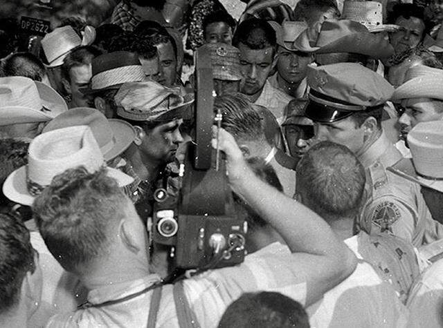 Gordon Yoder, a Dallas camera operator for a national news service, aims his camera at a Tarrant County assistant district attorney, Grady Hight, as angry Mansfield men surround them on Aug. 31, 1956, during the Mansfield school desegregation incident. Seconds later, Yoder’s camera was smashed as he was roughed up.