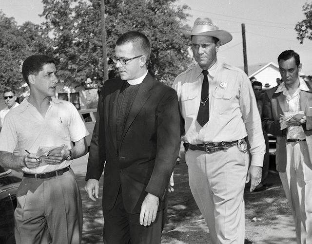 The Rev. D.W. Clark of St. Timothy’s Episcopal Church is escorted away from the mob at Mansfield High School after he was shoved on Sept. 4, 1956, during the Mansfield school desegregation incident. Texas Ranger Jay Banks of Dallas is escorting Clark.