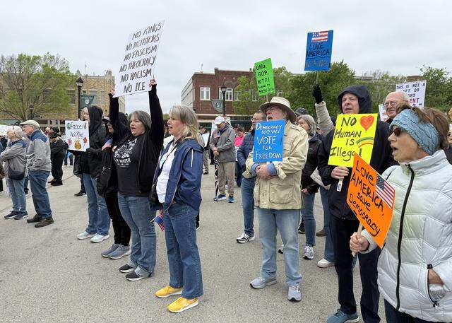 Several people who attended a “No Kings” protest in Southlake held up signs on Saturday morning, March 28, 2026. The speakers included Alisa Simmons, a Democratic Tarrant County commissioner who is running for county judge.