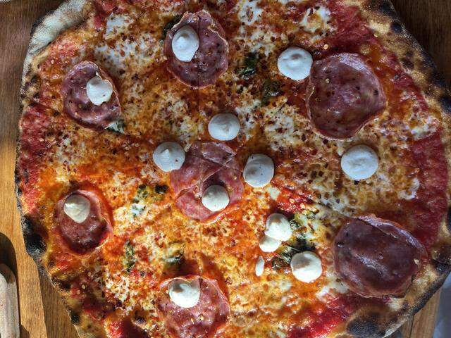 Felina’s Hot Mess pizza has tomato sauce, mozzarella, pecorino, basil, soppressata, whipped ricotta and hot honey.