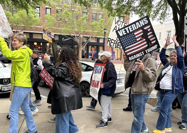 A crowd gathered at the Rustin and Family Park in Southlake Town Square for a “No Kings” protest on Saturday, March 28, 2026.