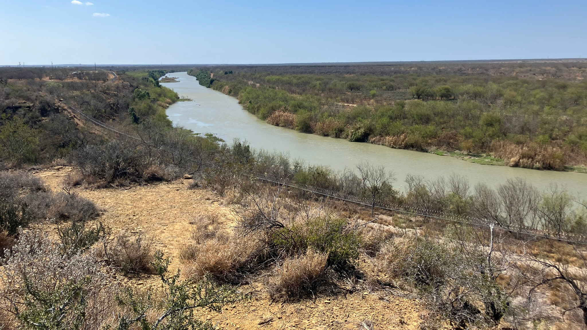 A view of the Rio Grande in Zapata County, Texas, where Customs and Border Protection plans to install cylindrical buoys. Border fencing is visible on the banks of the river. Credit: Martha Pskowski/Inside Climate News