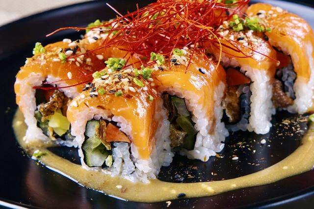 The “Cowboy Kiss” sushi roll with salmon, fried salmon skin, fish sauce caramel and yuzu at Nikuya Rooftop in Fort Worth, Texas.