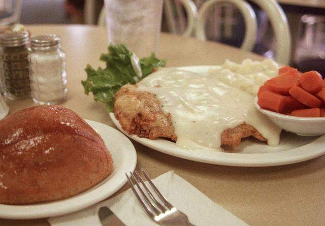 Chicken-fried steak, a roll, carrots and mashed potatoes at Bluebonnet Cafe in Haltom City, Texas, shown Oct. 27, 1998. That’s exactly how it looks today.