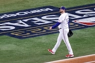 Texas Rangers starting pitcher Jordan Montgomery walks to the dugout after giving up a home...