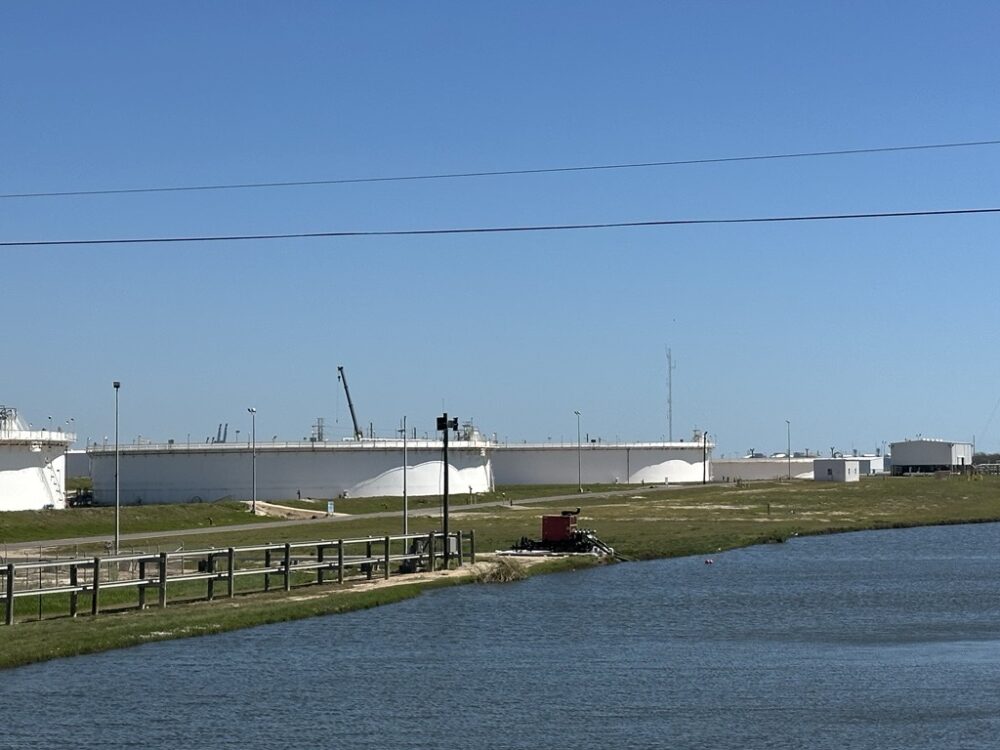 A row of tanks can be seen from the road near the Strategic Petroleum Reserve in Freeport, Texas.