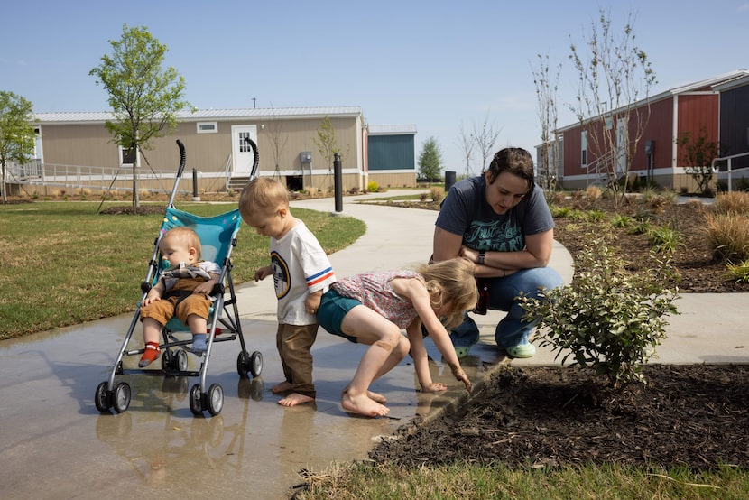(From left) Barnabas, 1, Judah, 2, and Hadassah, 4, take a stroll with mother, Anna Jenkins,...