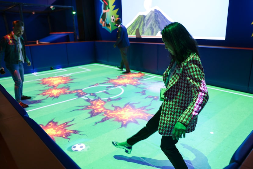 People play the field is lava interactive activity during the science of soccer exhibition,...