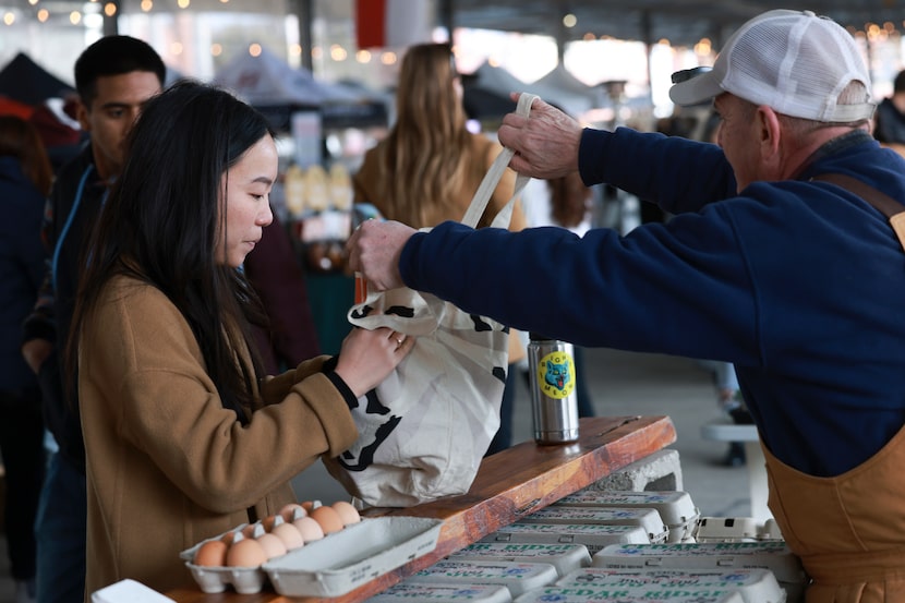 Annieky Yip, takes her bag filled with fresh duck eggs from Lee-Lynn’s Farm and Ranch at the...