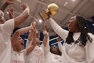 Lancaster head coach LaJeanna Howard, right, hoists the state semifinal trophy as she...