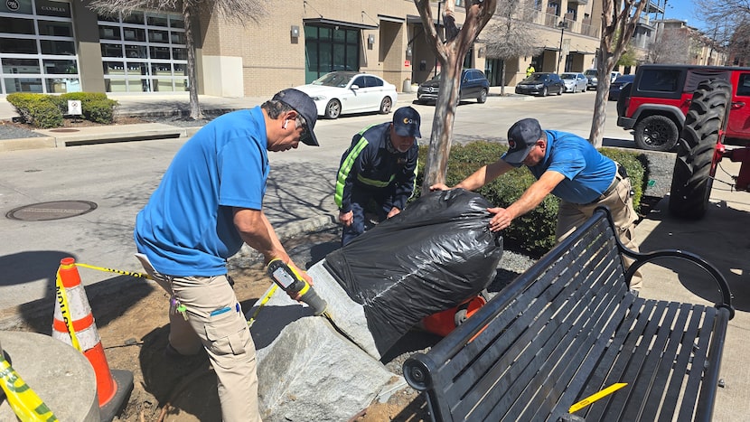 A worker uses a reciprocating saw to remove a statue of Cesar Chavez Thursday at the Dallas...
