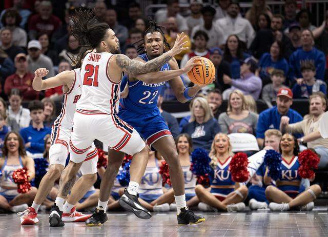 Kansas Jayhawks guard Darryn Peterson (22) handles the ball as Houston Cougars guard Emanuel Sharp (21) defends in the second half at the Big 12 Men's Basketball Tournament at T-Mobile Center on Friday, March 13, 2026, in Kansas City. Houston defeated Kansas, 69-47.