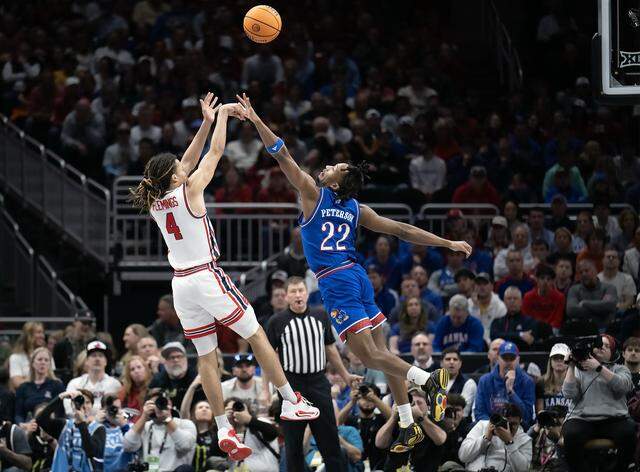 Kansas Jayhawks guard Darryn Peterson (22) defends as Houston Cougars guard Kingston Flemings (4) shoots in the first half at the Big 12 Men's Basketball Tournament at T-Mobile Center on Friday, March 13, 2026, in Kansas City.