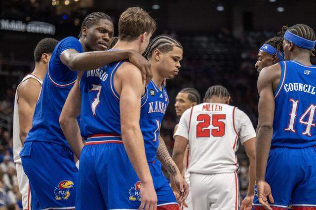 Kansas Jayhawks forward Flory Bidunga (40) puts his arm around Kansas Jayhawks guard Kohl Rosario (7) as the Jayhawks were losing to the Houston Cougars late in the second half at the Big 12 Men's Basketball Tournament at T-Mobile Center on Friday, March 13, 2026, in Kansas City. Houston defeated Kansas, 69-47.