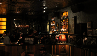 Kilmac's dark exterior livens up with bar backlighting and eclectic light fixtures.