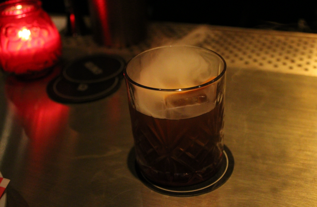 Smoke creeps out of Kilmac's Guinness Old Fashioned, which is made with Aztec Chocolate bitters.