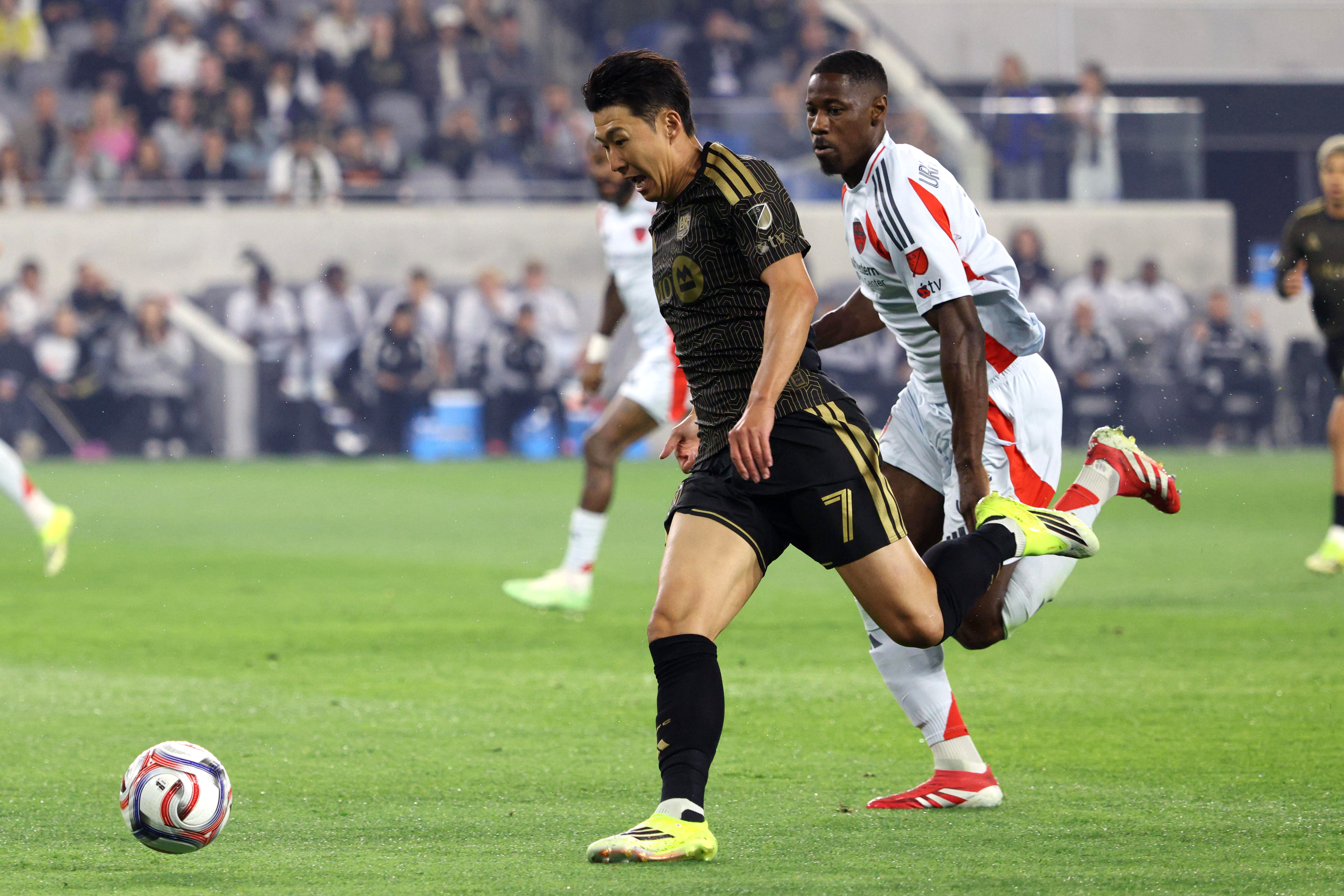 LAFC forward Son Heung-Min (7) chases the ball down defended...