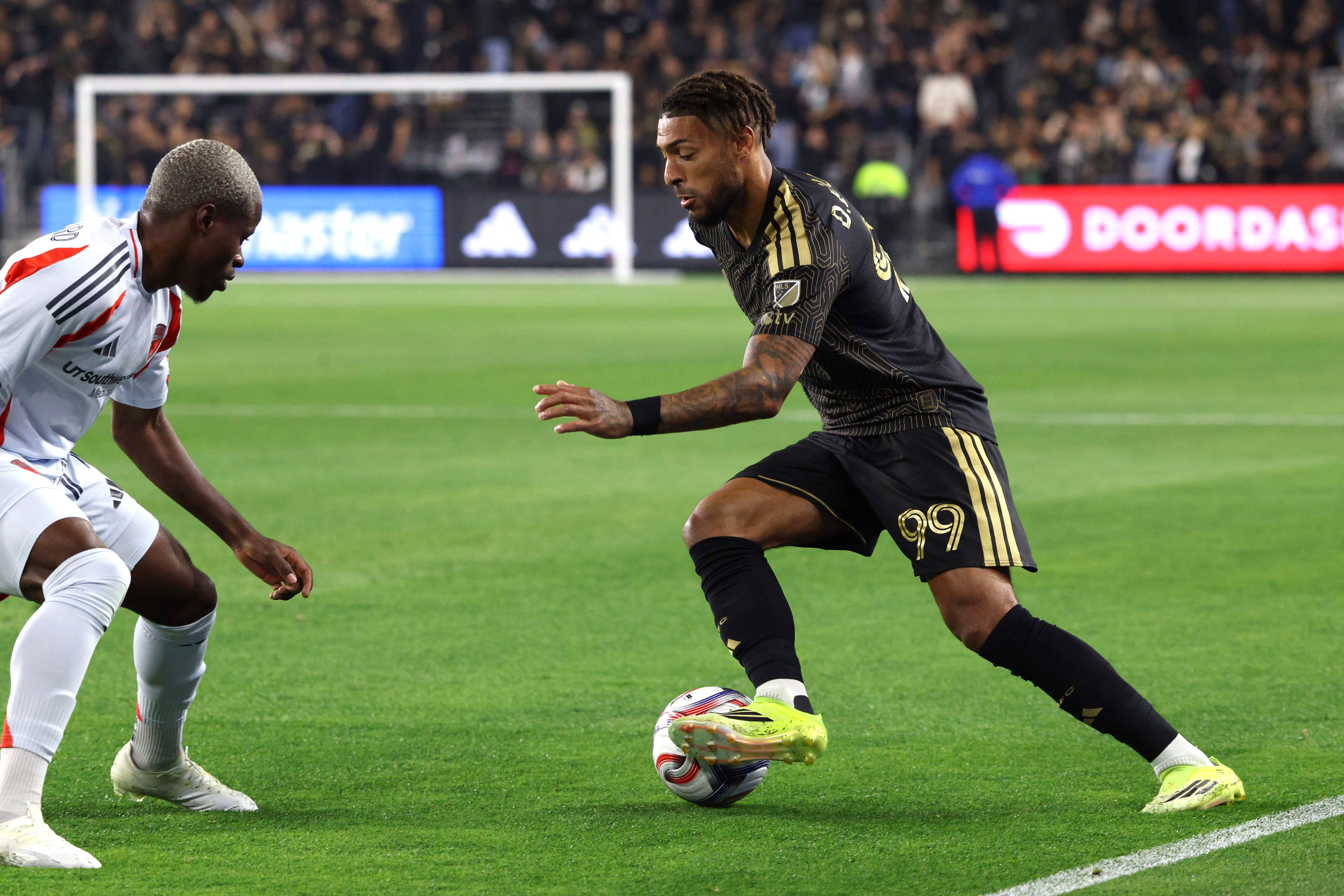 LAFC forward Denis Bouanga (99) kicks the ball against FC...