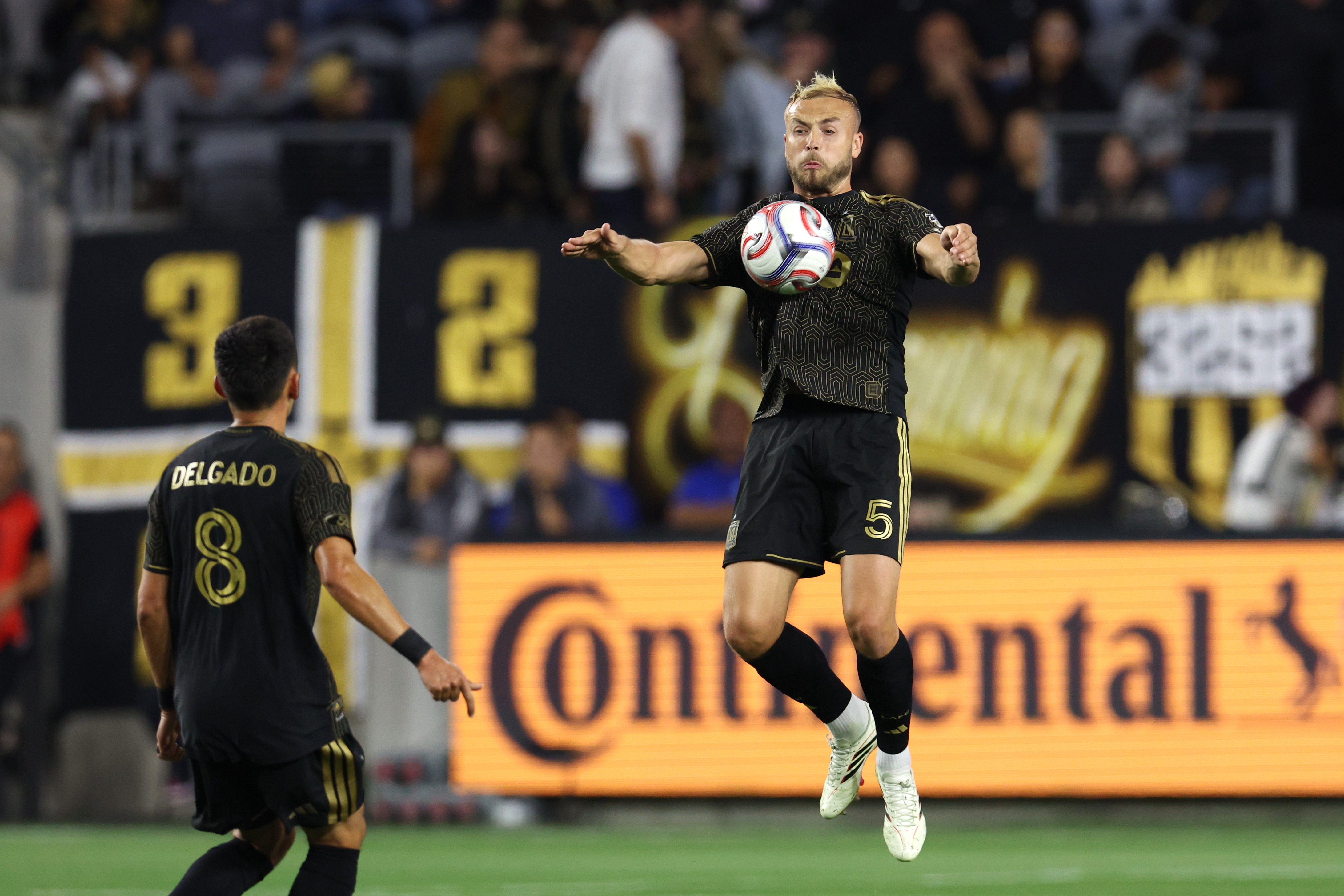 LAFC defender Ryan Porteous (5) deflects the ball off his...