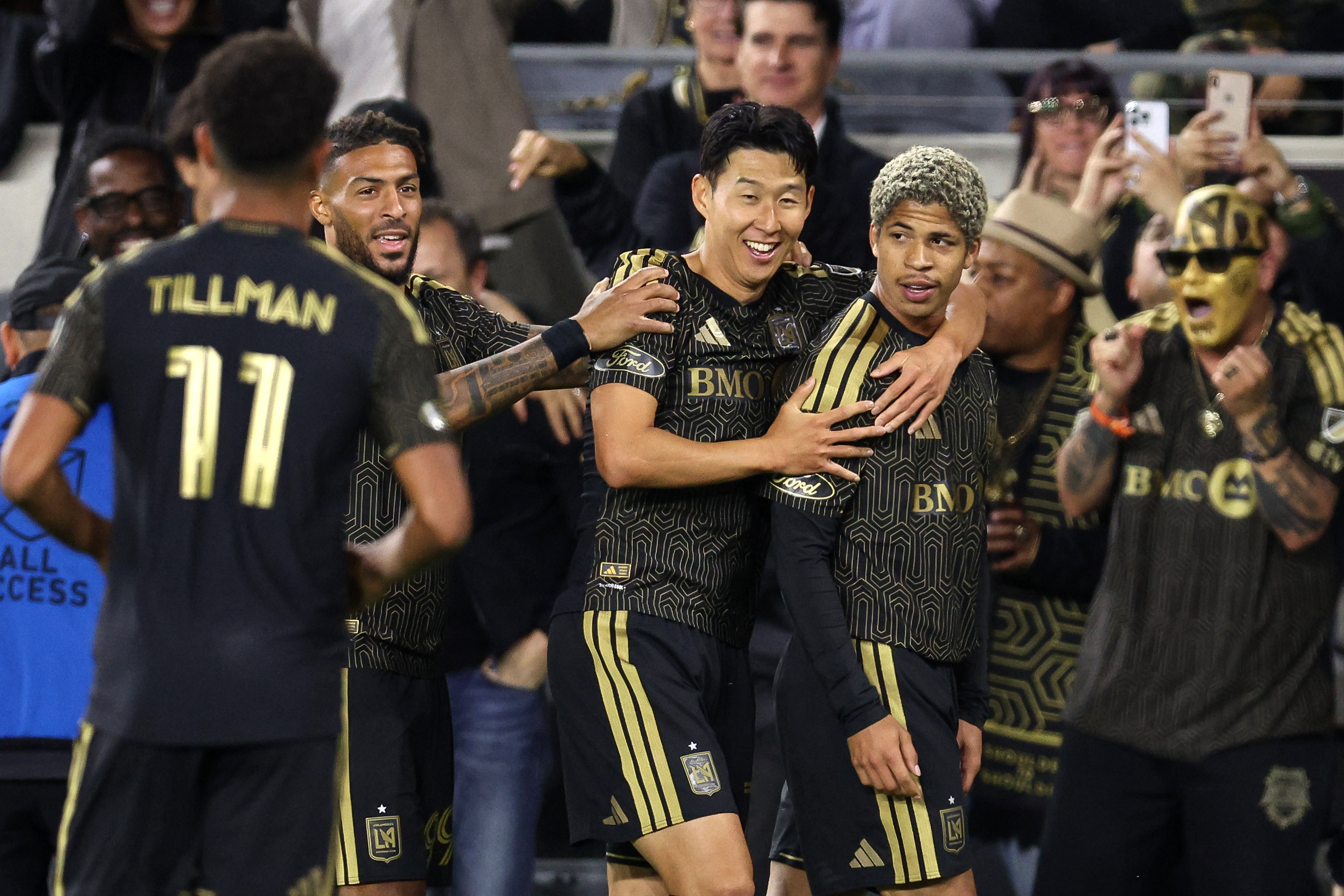 LAFC forward David MartÃnez, right, is hugged by forward Son...
