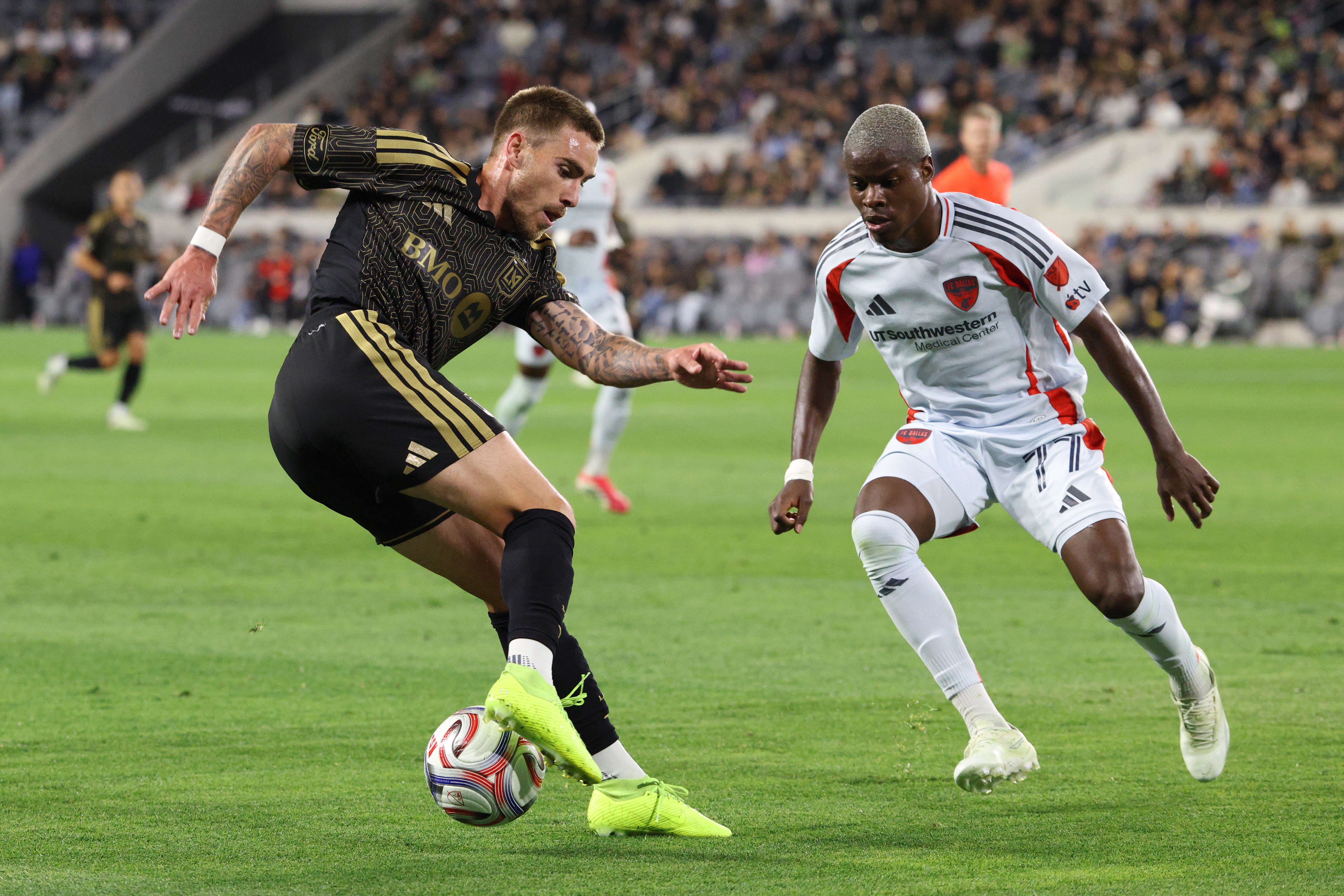 LAFC forward Tyler Boyd, left, controls the ball defended by...