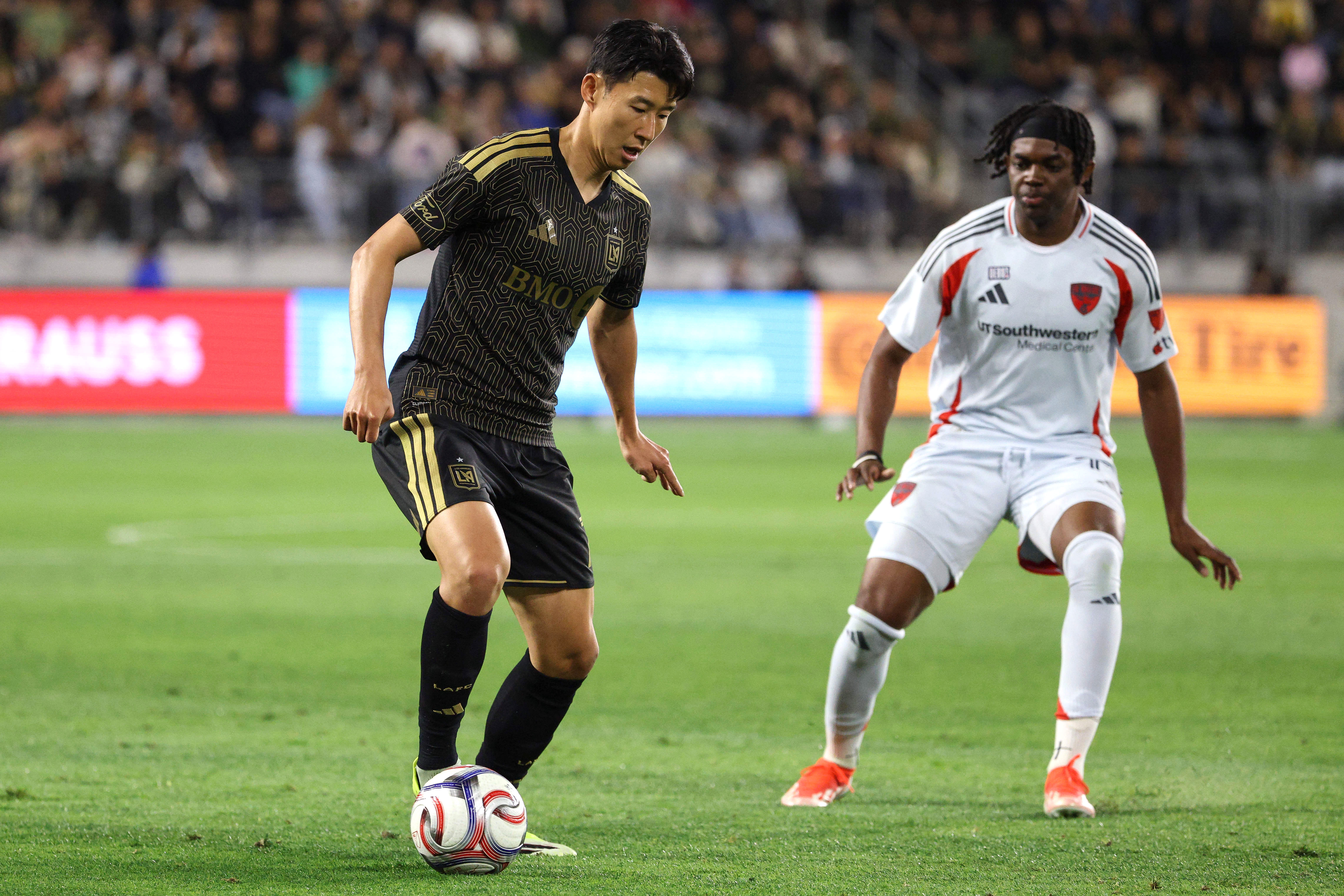 LAFC forward Son Heung-Min, left, controls the ball as FC...