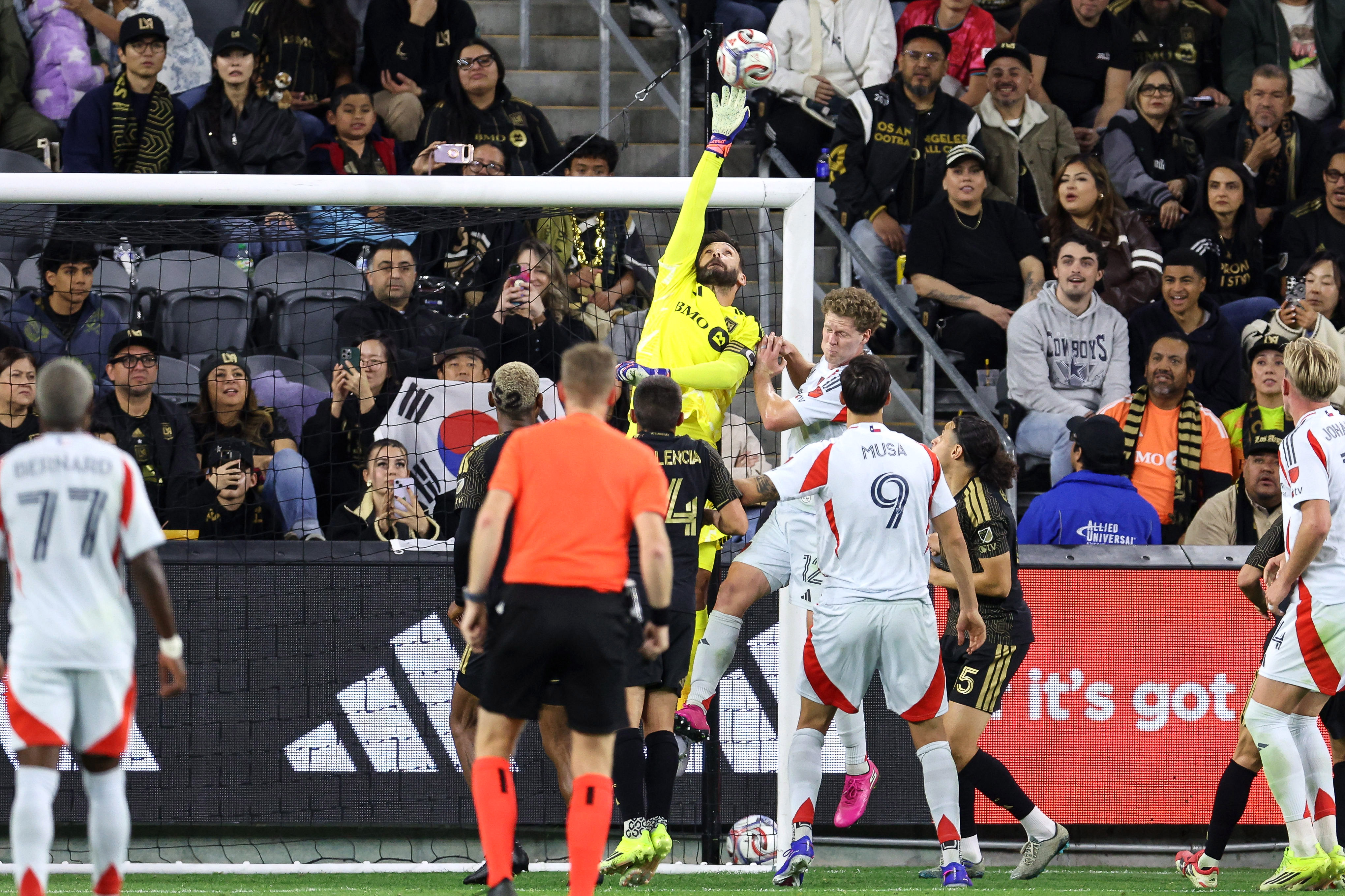 LAFC goalkeeper Hugo Lloris, top, deflects the ball against FC...