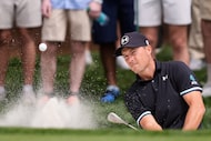 Jordan Spieth chips out of the bunker on the fifth hole during the third round of The...
