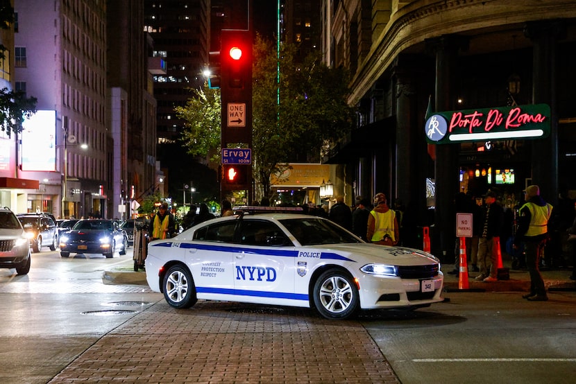 A New York Police Department vehicle drives off Ervay Street during filming for "The...