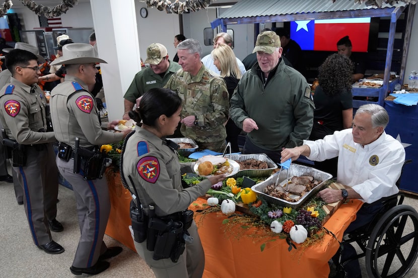 Incoming U.S. Border Czar Tom Homan (second from right) and Texas Gov. Greg Abbott (right)...