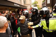 Dallas police detain a man at the No Kings protest in downtown Dallas on March 28, 2026.
