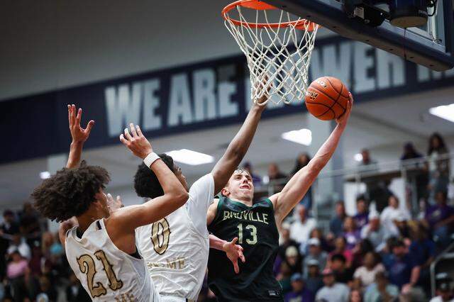 Birdville guard Avery Webb (13) drives to the basket to attempt a shot while two Denton defenders close in on him in a UIL Class 5A Division I regional final at Flower Mound High School in Flower Mound, Texas, Friday, March 6, 2026.